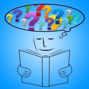 cartoon of child reading book with question marks above - Copy